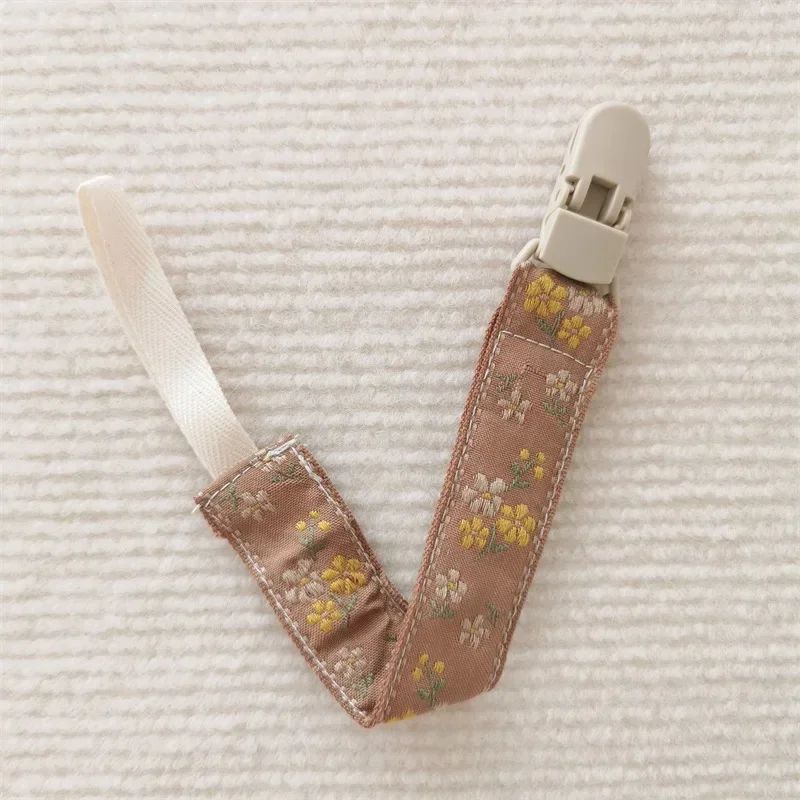 attache sucette nomade fleur jaune
