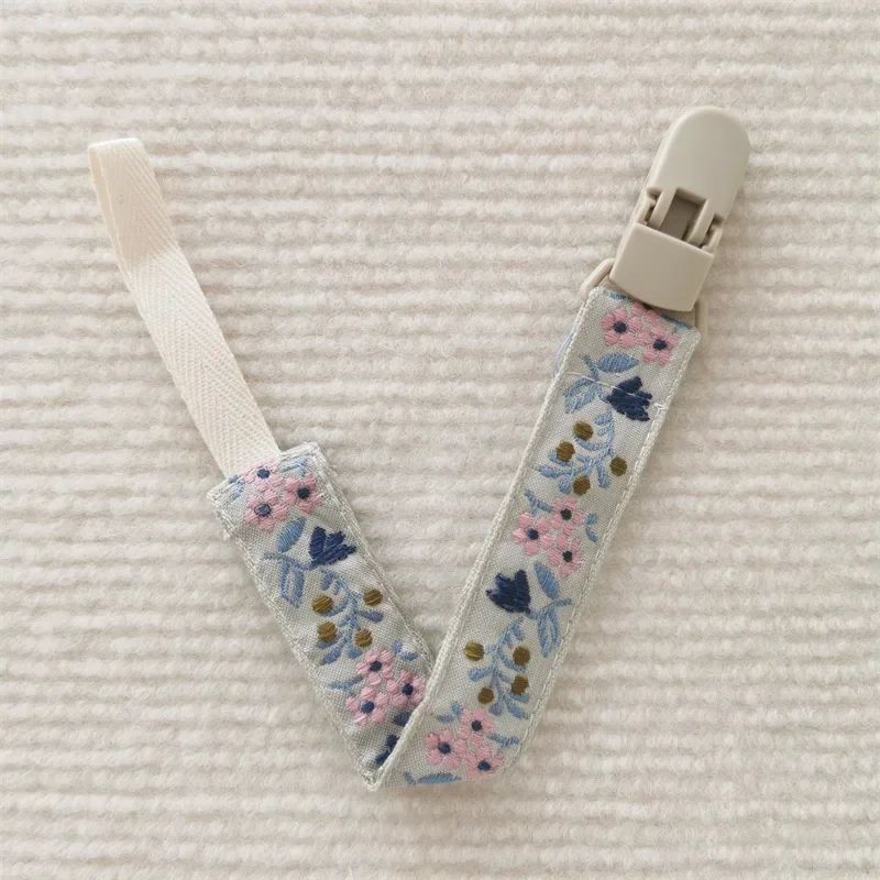 attache sucette nomade fleur rose