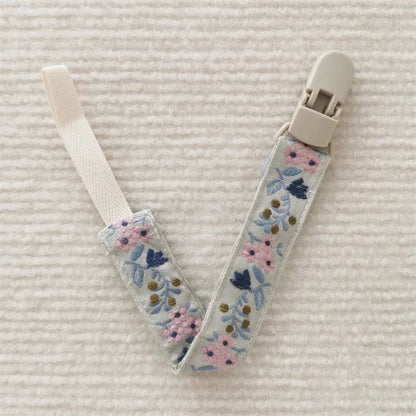 attache sucette nomade fleur rose
